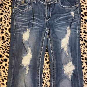 Distressed dark blue jeans